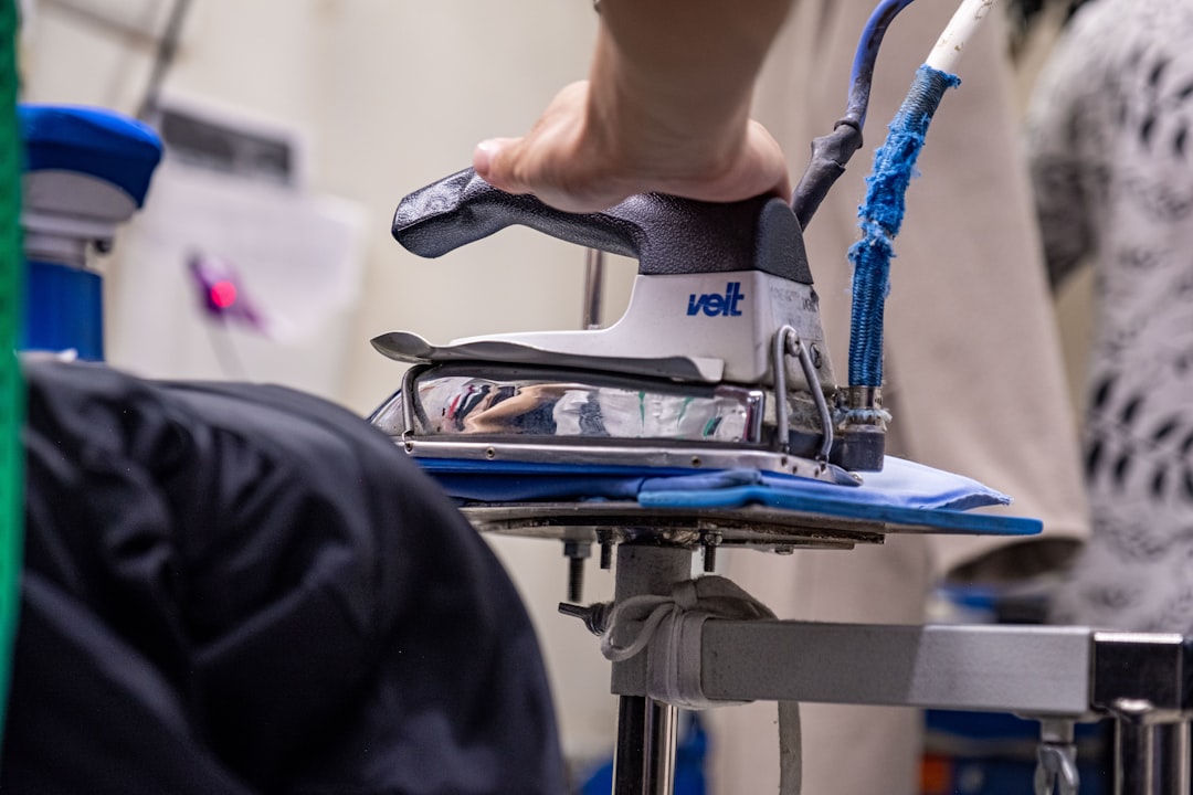 why-choose-us a-close-up-of-a-person-ironing-a-shirt-gemrf7xa7hs