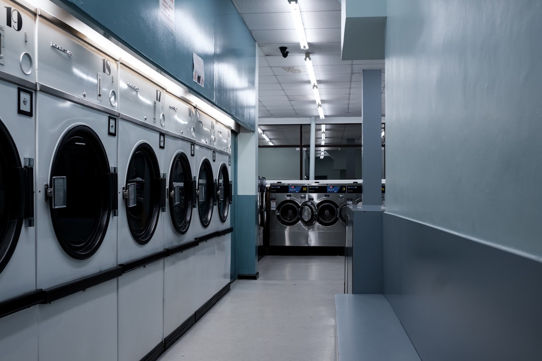 portfolio-01 Local launderette business at night time, lots of washing machines and tumble dryers. An empty store illuminated by fluorescent light in Bristol, UK. 2/5